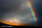 Rainstorm with rainbow over Rondane