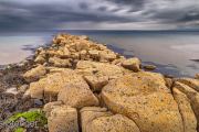 Strongly eroded rocky (Geological) dike at the southwest coast of the isle of Arran